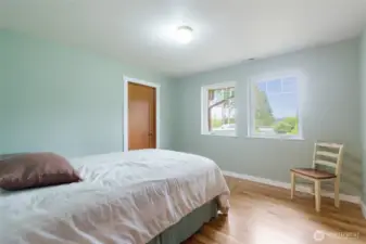 Main Floor Guest Bedroom, One of three bedrooms conveniently located on the main floor, offering comfortable and private living space for family or guests.