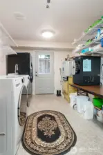 his spacious laundry area includes wiring for an electric range, offering the potential to be converted into a future kitchenette—perfect for creating an independent living space or enhancing multi-generational functionality. Current range will not stay