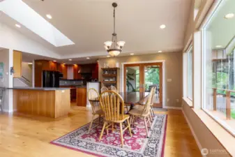 Bright and inviting, the dining space offers easy access to the kitchen and covered deck, making indoor-outdoor meals a breeze. Enjoy your meals while taking in beautiful views that create the perfect backdrop for every gathering.