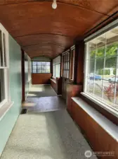 Barrel-rolled ceiling runs the length of the enclosed porch area.
