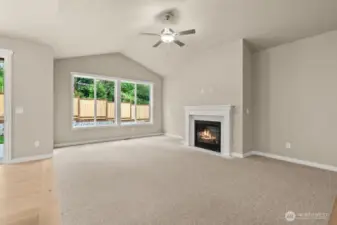 Large living room feature vaulted ceiling, ceiling fan and gas fireplace