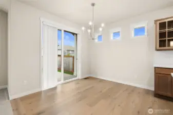 Dining nook with slider door to backyard.