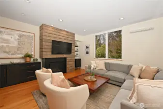 Exceptional details like white oak flooring and the interest of rough hewn boards accenting the fireplace