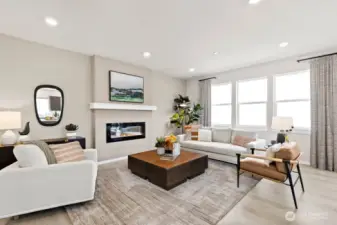 Great room with cozy fireplace and ample windows to relax.  Photos are representational. Actual colors and finishes will vary. See site agent for details.