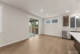 Dining area off kitchen island can accommodate large dining table.  Great photo showcasing large open concept great room. Actual home is under construction and materials, colors, and finishes will vary. See site agent for details.