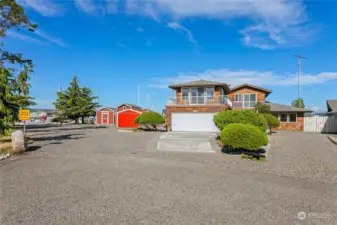 A view of both parcels at the end of the cul-de-sac. In addition to the home there are 3 outbuildings, and 2 docks with power and water, and ample parking space