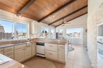 The light and bright kitchen has beautiful water views throughout