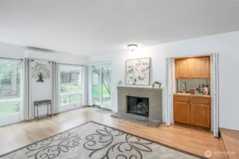 Living room features a wood burning fireplace and wet bar!