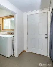 Just beyond the kitchen, you’ll find this utility area with tons of hidden storage and a door leading right to the backyard—perfect for storage, pantry and more!