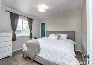 Spacious and serene, this primary suite comfortably fits a king-size bed—with room to spare. A peaceful retreat at the end of each day.