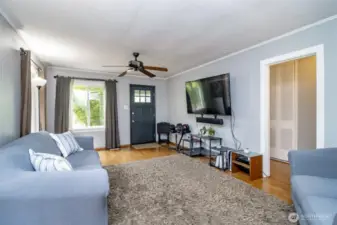 Light pours in from both sides, making this room feel bright, open, and inviting—perfect for relaxing after a long day or welcoming friends through the front door.