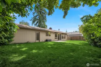 Spacious flat fenced backyard.
