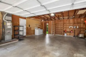 Large spacious garage with storage.  Connected shed (not shown) provides additional storage.