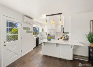 Gorgeous remodeled kitchen with plenty of counter tops and bar stool area, along with a beautiful view of the Hood Canal!