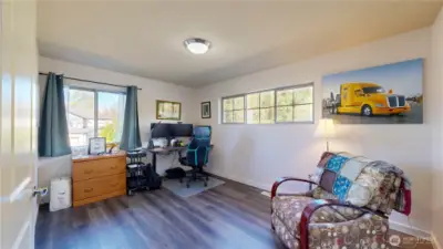 Spacious bonus room with French door entry perfect for a home office, media room, or flex space.