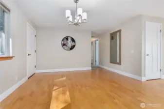 From the kitchen to the dining area and front entry on the left.