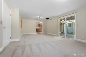 The main family room looking towards the Sunroom on the right, the kitchen straight ahead and the garage on the left.