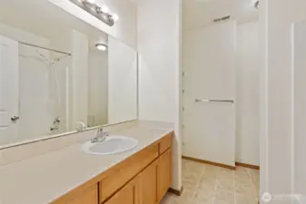 Lower Level full bathroom with shelving unit for storage