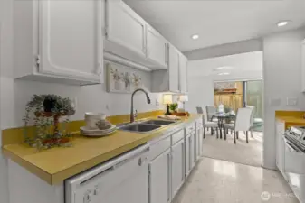 Darling kitchen with lots of cabinetry, newer microwave, dishwasher and fridge.