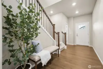 Durable luxury vinyl plank flooring extends throughout the entire main level, blending style and practicality. Its rich tone adds warmth to the open-concept spaces while offering easy maintenance and everyday resilience—perfect for both entertaining and busy living.