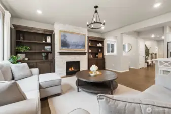 A custom fireplace creates a cozy focal point for gatherings year-round. The open layout keeps everyone connected.