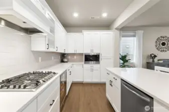 You'll love the gas cooktop, wine fridge, double ovens, custom range hood and build in microwave. The oversized island invites gathering, conversation, convenient meal prep and effortless hosting.