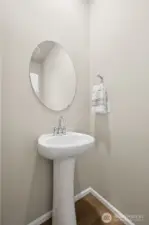 A conveniently located main floor half bath offers comfort and practicality for guests. Thoughtfully positioned away from the main living areas, it provides privacy while remaining easily accessible.