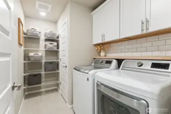 Ample storage throughout the home keeps daily life organized. Clean lines and thoughtful design create a clutter-free feel. This beautiful, upstairs laundry room is conveniently located close to bedrooms.