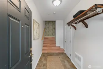 Step into a generously sized entryway that offers a warm and inviting first impression, with convenient access to the garage just to the right.