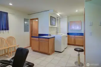 To the left is a full bath and there is a laundry space.  It would be perfect for a little kitchenette space for guests.