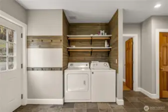 Main floor laundry area/mudroom.Washer & Dryer stay! Beautiful slate floors.
