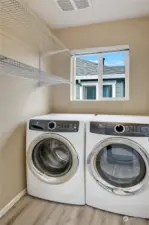 The laundry room is also conveniently located between the bedrooms.  The full-size Electrolux washer and dryer stay with the home.  This room also has durable laminate hardwood flooring, plus wire shelving.