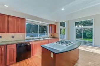 Warm wood cabinets are set off by a mix of slab granite counters.