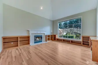 Built-in bookcases flank the gas fireplace in the living room and wrap around most of the room.