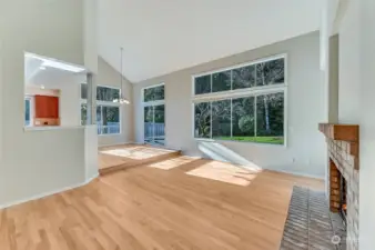 The family room off the kitchen has dramatic vaulted ceilings and the wood burning fireplace has a gas started so it could be converted to a gas fireplace.