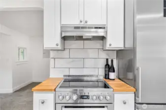 A touch of butcher block warmth frames the cooking space, blending efficiency and style in perfect balance. Ideal for any home chef or weekend cook who values both form and function.