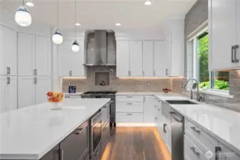 Quartz countertops, an undermount sink with a hot water dispenser, while a walk-in pantry ensures effortless organization.