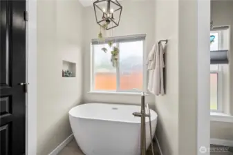 The ensuite is paired with a decadent soaking tub for ultimate relaxation.