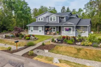 The garage, equipped with a Tesla charging station, caters to an eco-conscious lifestyle.