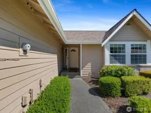 Beautiful paved entry way with a covered front door