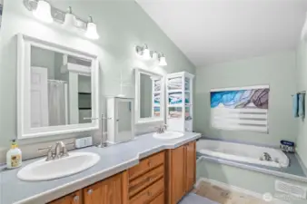 Updated bathroom with double sinks and large soaking tub.