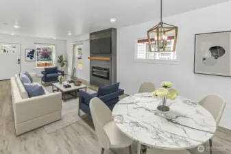 Virtually staged. View from dining room into living room and front door