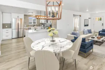 Virtually staged. Dining room with a view of the updated kitchen