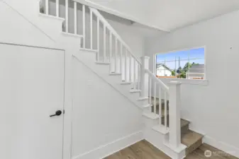 Stairway up to second level. Good sized storage closet with light.