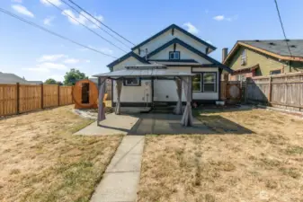 View of the back of the home with a gazebo.