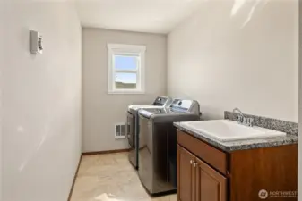 Upper level laundry room w/utility sink + storage
