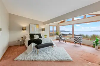 Large primary bedroom on second level boasts a view as large as the room itself.