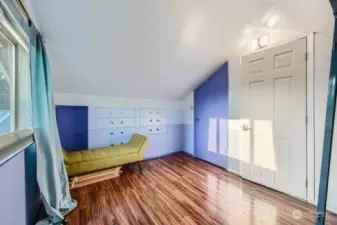 Another view of the upper level bedroom with built-in drawers.