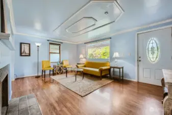 Spacious living room with gleaming floors that flow throughout the home.