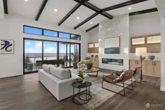 Simply stunning!  Wrap yourself in modern luxury with a space that was made for sophisticated entertainment. The warmth of the exposed rafters paired with the oversized expansive tiled wall surrounding a linear 72" fireplace create nothing short of beautiful.